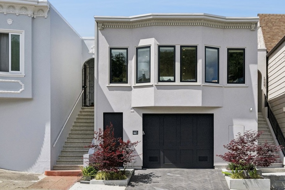 Elegant facade with east wall of windows; irrigated plantings